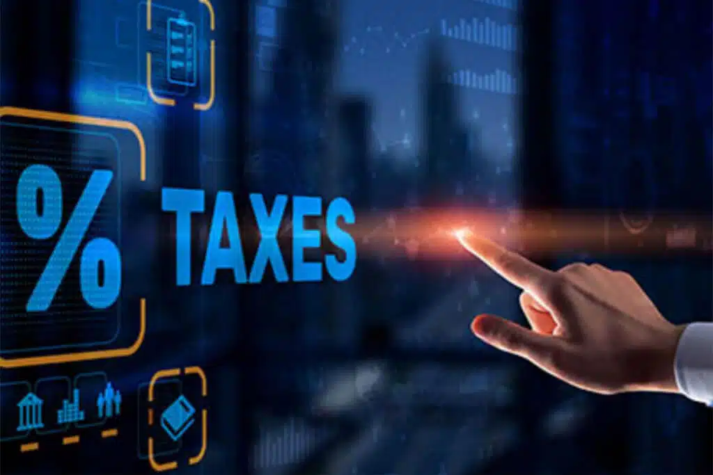 closeup image of a handing pointing to a graphic depicting taxes