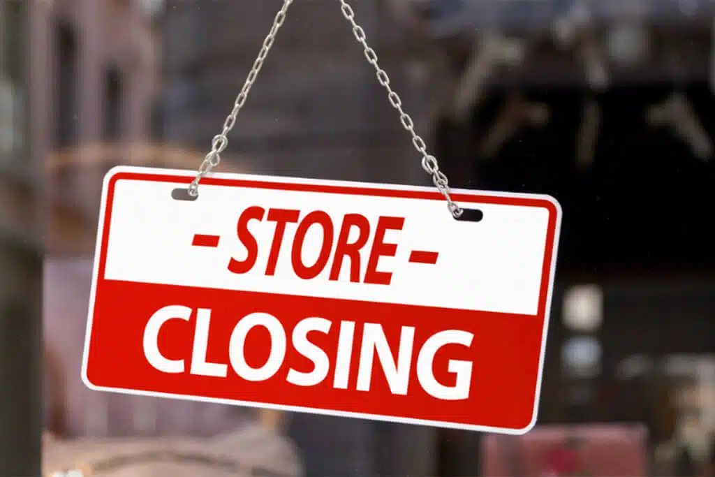 close up of store closing sign in a window